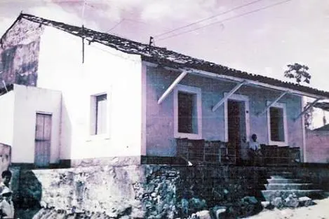 Fachada de uma construção antiga com escadaria e telhado de barro